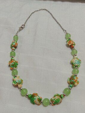 Pretty handmade necklace with little turtles and glass bead